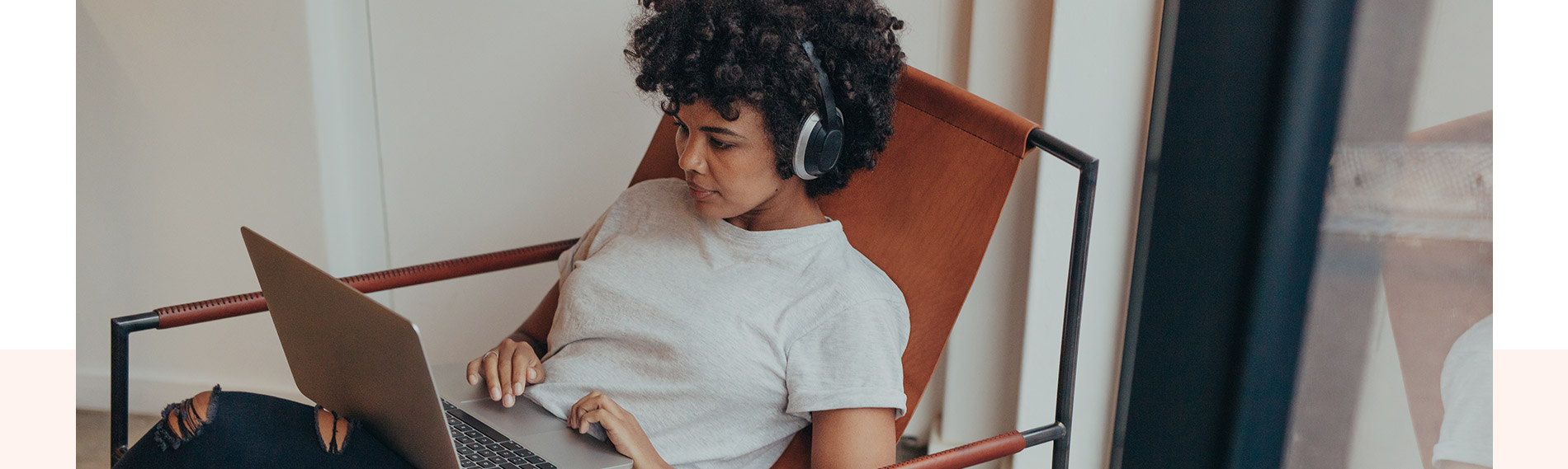 A woman sitting in a chair wearing headphones.